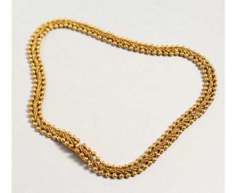 A BUTLER &amp; WALKER GILT NECKLACE.