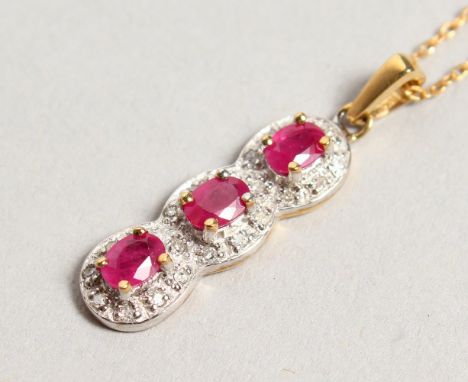 A 9CT GOLD, RUBY AND DIAMOND PENDANT on a chain.
