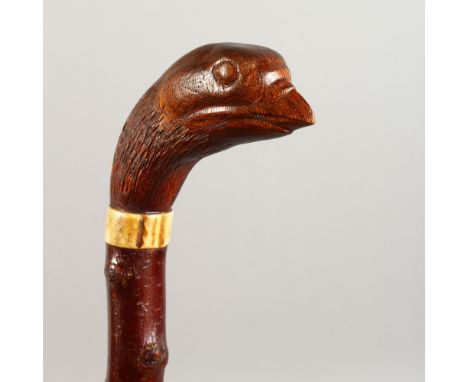 A WALKING STICK, the handle carved as a game bird. 38ins long.