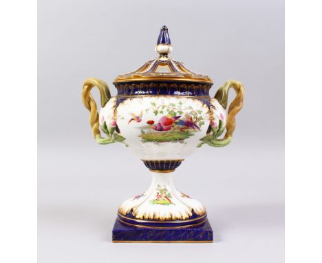 A ROYAL WORCESTER URN, COVER AND STAND, blue and white ground, painted with birds and flowers. Pattern 2324.  12ins high.