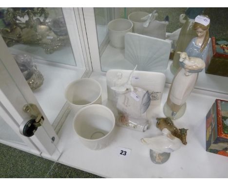 Collection of Lladro to include two cabinet plaques, Woman with Lamb, Duck, Camel and 2 unglazed pots 