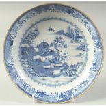 AN 18TH CENTURY CHINESE BLUE AND WHITE PORCELAIN DISH, decorated with a temple within a landscape