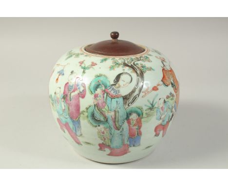 A 19TH CENTURY CHINESE FAMILLE ROSE PORCELAIN JAR AND WOODEN COVER, painted with a joyous scene of many figures and children 