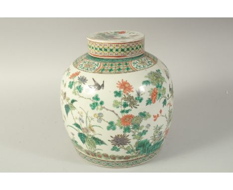 A LARGE CHINESE FAMILLE VERTE PORCELAIN JAR AND COVER, enamel painted with birds and flora, together with a spare cover (poss