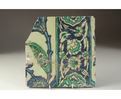 A FINE EALY 17TH CENTURY OTTOMAN DAMASCUS GLAZED POTTERY TILE, with floral decoration, (af), 25cm x 25.5cm.
