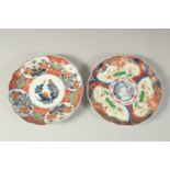 TWO JAPANESE IMARI PORCELAIN PLATES, painted with panels of flora and gilt highlights, one with