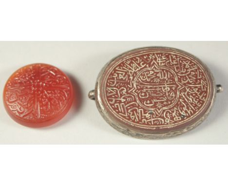A FINE 19TH CENTURY INDIAN ENGRAVED AGATE AMULET, with silver backing, along with another engraved agate seal, (2).