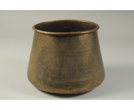 AN ISLAMIC ENGRAVED BRASS BASIN, 17cm high.
