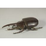 A BRONZE OKIMONO OF A RHINOCEROS BEETLE, with hinged lid, 10.5cm long.
