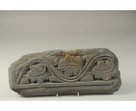 A FINE AND LARGE GANDHARA CARVED GREY SCHIST STONE PANEL, depicting grape vines, 43cm long.