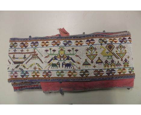 AN EARLY 20TH CENTURY WESTERN INDIAN GUJARAT LONG BEADWORK PANEL, with polychrome stylised geometric designs on white ground,
