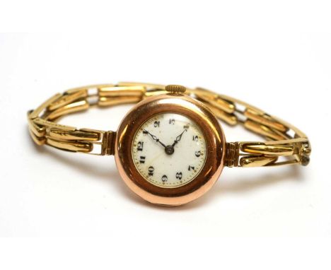 A 9ct yellow gold cased Rolex cocktail watch, with white enamel arabic dial fitted a 15 jewel manual wind movement, on 9ct go