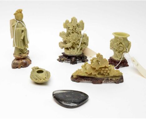 A collection of Chinese soapstone carvings, including: a miniature tea pot; a floral twin handled vase; a female figure; and 