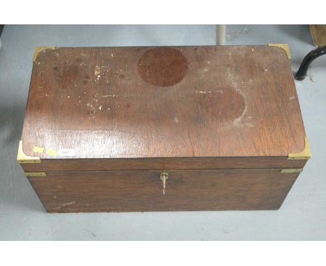 An early 20th Century brass bound mahogany trunk, of rectangular form, with key, 65cms wide.