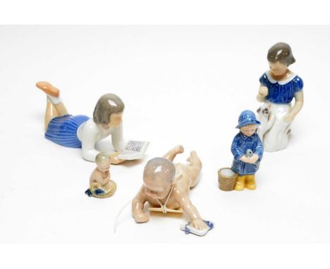 A collection of Royal Copenhagen decorative ceramic figures, including: Child Crawling with Sock, 15cms long; a Fisher Boy wi