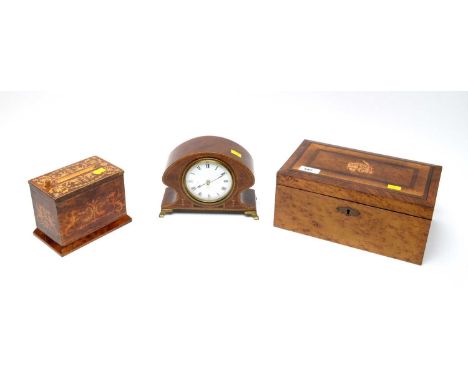 An Edwardian inlaid walnut mantel clock, on splayed bracket feet, with later Quartz movement; a walnut inlaid and inkwork cig