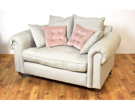 A large contemporary Barker and Stonehouse armchair, upholstered in light grey patterned fabric, the scrolled elbow rests fla