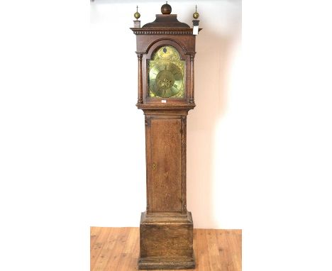 A 19th Century oak longcase clock signed Peter Hogg, the brass dial with arabic chapter ring, urn and foliate spandrels, date