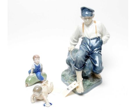 A Royal Copenhagen decorative ceramic figure of  Shepherd Boy on Rock, 32cms high; together with two other Royal Copenhagen f