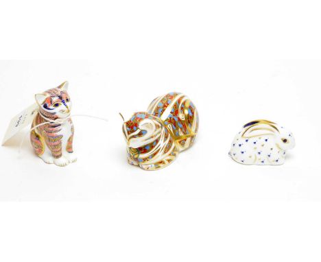 A collection of three Royal Crown Derby ceramic animal paperweights, comprising: two cats; and a rabbit, each with printed ma