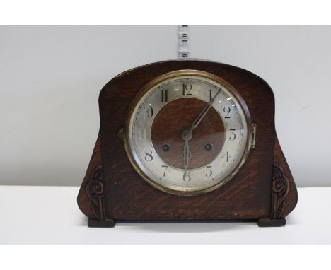 A antique wood cased mantle clock 