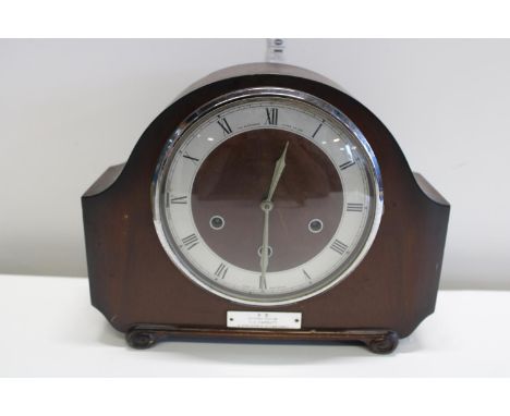 A antique wood cased mantle clock 