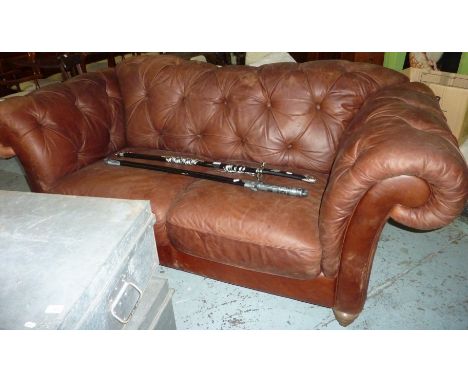 Extremely large Chesterfield style brown leather two seat sofa on turned supports and matching arm chair 