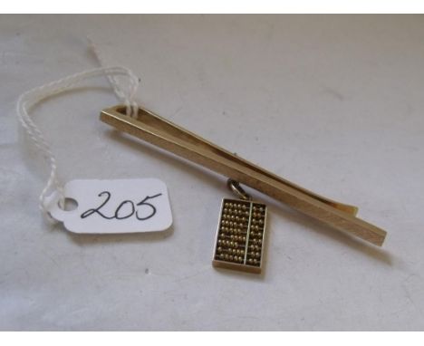 An unusual 14k gold tie clip with Abacus charm attached 9.1g        