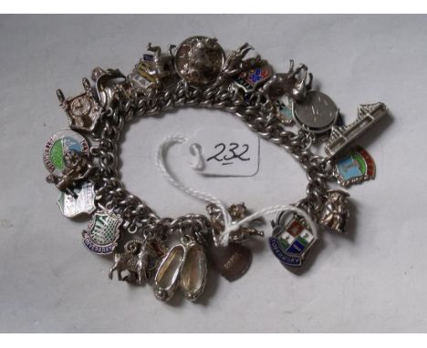 A vintage silver charm bracelet set with multiple charms 68g        