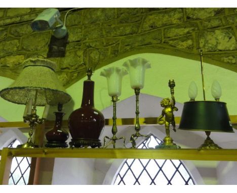 A pair of slender brass electronic table lamps with faceted baluster stems raised on sweeping tri supports, a substantial tab
