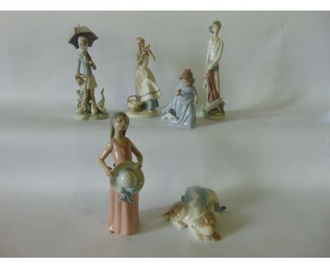 A collection of Lladro figure groups including a model of Don Quixote, a girl holding a wide brimmed hat, a girl holding an u
