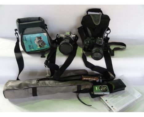 A Canon EOS 500N camera, a Fuji Finepix S9500 camera (both in bags), a Canon IXUS digital camera and a Compact DB-3 tripod