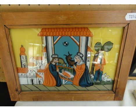 A painting on glass panel of a nativity scene incorporating Mary, Joseph and a baby, a shepherd playing a pipe, etc, probably