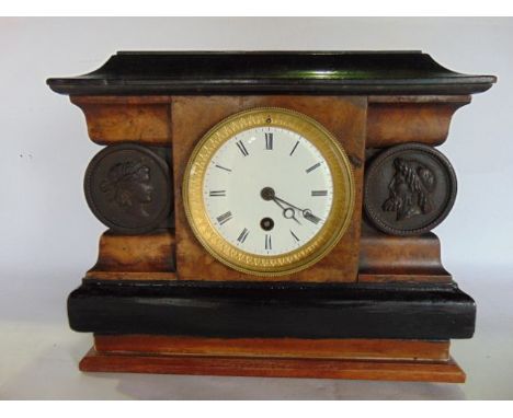 A 19th century mantle clock of classical sarcophagus form, the timber case set with burrwood veneers with ebonised frieze and