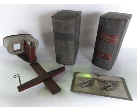 A vintage stereoscopic viewer, principally in mahogany with chased detail to the metallic frame, with sun sculpture (logo), a