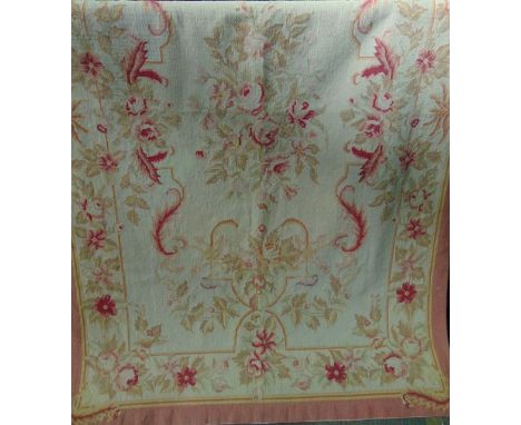 An Aubusson style tapestry carpet with cream ground and extensive foliate decoration in shades of pale and light pink, green,