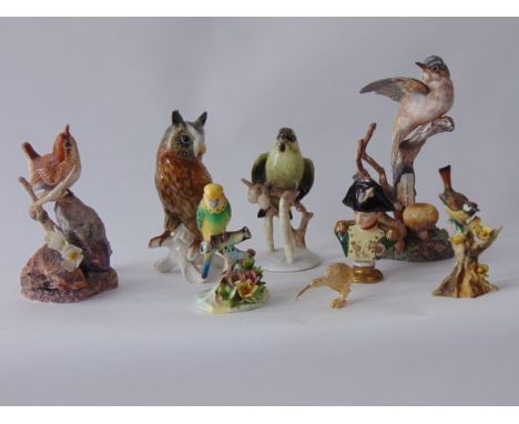 A collection of ceramic models of birds including two matt glazed models of a white throat and a wren from the Hereford Fine 