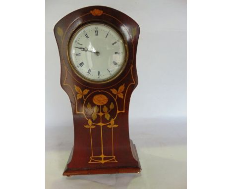 A late 19th/early 20th century mantle clock of shaped and tapering pillar box form, the mahogany case with stained stylised f