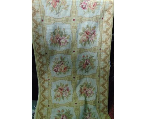 An Aubusson style tapestry panel with medallion field, centred by floral sprays, set within an alternating borders within a c