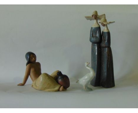 A collection of three pieces of Lladro Daisa ware comprising a matt glazed model of two nuns, a matt glazed model of a reclin