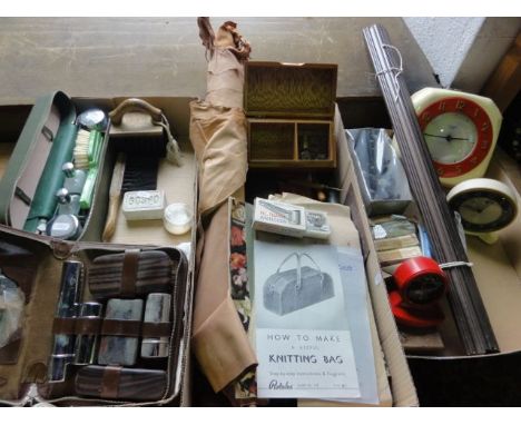 A box containing an assortment of glove making accessories to include rolled lengths of treated leather in various colourways