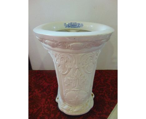 An early 20th century ceramic lavatory pan with cream glaze and relief moulded scrolling and leaf decoration, with blue print
