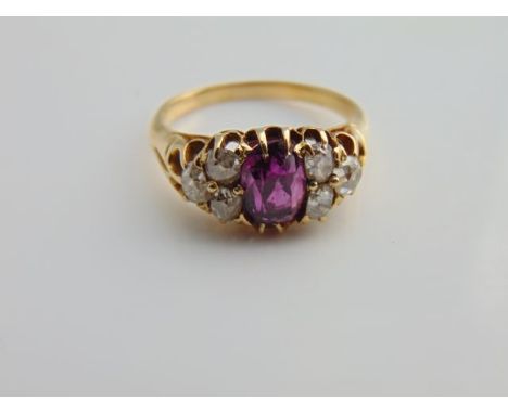 A Victorian ring, centred with an oval old-cut untested almandine garnet weighing approximately 2.0cts, flanked to each shoul