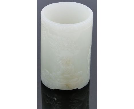 A Chinese relief-carved jade brush pot,
with carved Buddha decoration, height 3.25".