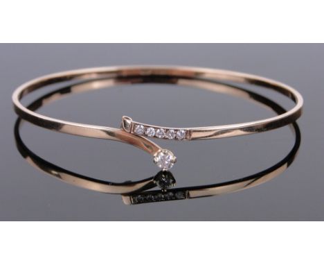 A 9ct gold diamond set bangle, 5.5g.