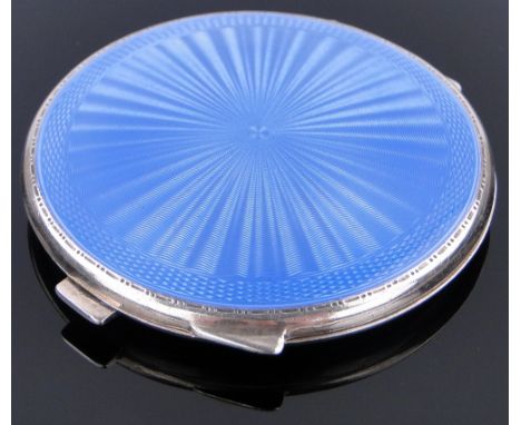 A circular silver and blue guilloche enamel compact,
7 cm across.