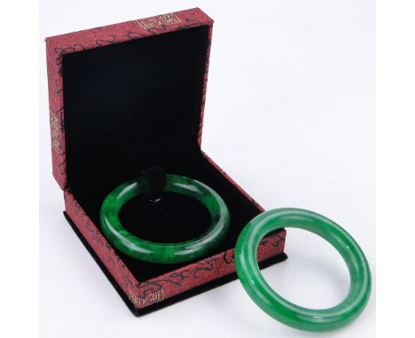 A Chinese jade bangle,
3" diameter, boxed and another jade bangle, (2).