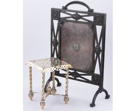 A Victorian pierced brass trivet,
height 11", width 9", and a firescreen with inset copper panel.