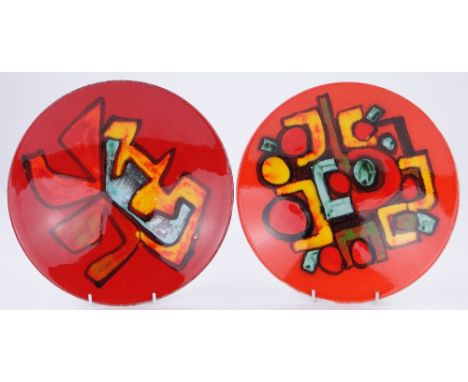 2 Poole Pottery Delphis chargers,
each with painted abstract design on orange ground, 10.5".