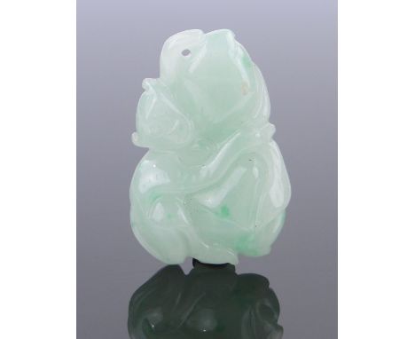 A Chinese carved jade monkey design pendant,
length 35mm.